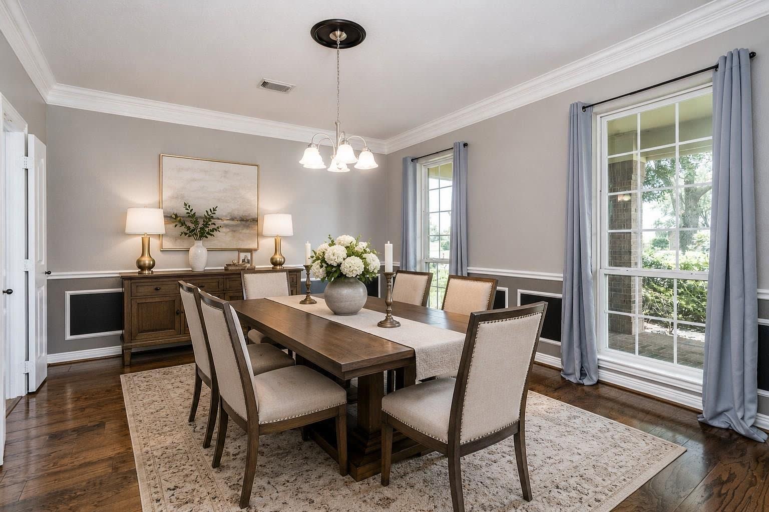 Gourmet kitchen with granite island, wood cabinetry, and a view through to the family room
