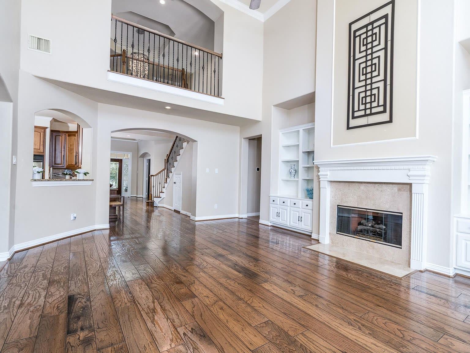 Primary suite with a sitting area and windows to the wooded lot